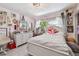 Bright bedroom with white bedding and a dresser at 221 Howard Dr, Belleair Beach, FL 33786