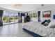 Main bedroom with blue velvet bed and pool view at 221 Howard Dr, Belleair Beach, FL 33786