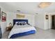 Main bedroom with blue velvet bed and pool view at 221 Howard Dr, Belleair Beach, FL 33786