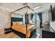 Elegant main bedroom with a four-poster bed and a sitting area at 221 Howard Dr, Belleair Beach, FL 33786