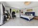 Main bedroom with blue velvet bed and pool view at 221 Howard Dr, Belleair Beach, FL 33786