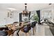 Elegant dining room features a live edge table and black leather chairs at 221 Howard Dr, Belleair Beach, FL 33786