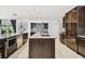 Sleek kitchen with dark wood cabinets and stainless steel appliances at 221 Howard Dr, Belleair Beach, FL 33786