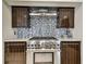 Modern kitchen features stainless steel appliances and mosaic backsplash at 221 Howard Dr, Belleair Beach, FL 33786