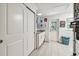 Bright laundry room with white cabinets and tile flooring at 221 Howard Dr, Belleair Beach, FL 33786