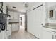 Clean laundry room with white cabinets and tile floor at 221 Howard Dr, Belleair Beach, FL 33786