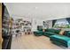 Spacious living room with green sectional sofa and built-in shelves at 221 Howard Dr, Belleair Beach, FL 33786