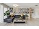 Chic living room with black leather sectional sofa and gallery wall at 221 Howard Dr, Belleair Beach, FL 33786