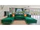 Living area features a green sectional sofa and fireplace at 221 Howard Dr, Belleair Beach, FL 33786