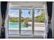 View of a pool and canal from inside the house at 221 Howard Dr, Belleair Beach, FL 33786