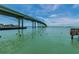 Scenic waterway view with bridge and calm water, birds present at 221 Howard Dr, Belleair Beach, FL 33786