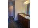 Bathroom featuring a double sink vanity with granite countertop and hexagon tile flooring at 277 Valencia Cir, St Petersburg, FL 33716