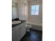 Bathroom featuring a black countertop, white vanity and black tiled floors at 277 Valencia Cir, St Petersburg, FL 33716