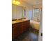 Bathroom with dual sink vanity, granite countertop, and freestanding soaking tub at 277 Valencia Cir, St Petersburg, FL 33716
