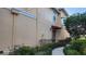 Townhouse exterior with landscaped walkway and red awning at 277 Valencia Cir, St Petersburg, FL 33716