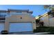 Two-story home featuring a large, white garage door and neutral-colored stucco exterior at 277 Valencia Cir, St Petersburg, FL 33716