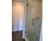 Bathroom featuring a glass shower with marbled tile and dark hexagon tile flooring at 277 Valencia Cir, St Petersburg, FL 33716