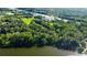Wide aerial view of property and surrounding waterfront community at 17210 Orangewood Dr, Lutz, FL 33548