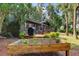 Large backyard with deck, raised garden bed, and lush landscaping at 17210 Orangewood Dr, Lutz, FL 33548