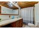 Clean bathroom with a double vanity, shower, and a wood vanity at 17210 Orangewood Dr, Lutz, FL 33548
