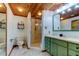 Bathroom with green vanity, shower, and tiled floor at 17210 Orangewood Dr, Lutz, FL 33548