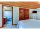Bright bedroom with ensuite bath and sliding wood doors to closet at 17210 Orangewood Dr, Lutz, FL 33548
