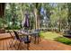 Back deck with lake view, table and chairs, and umbrella at 17210 Orangewood Dr, Lutz, FL 33548