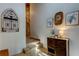 Stylish entryway with wooden cabinet, wall decor, and a staircase at 17210 Orangewood Dr, Lutz, FL 33548