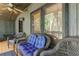 Inviting front porch with wicker seating and serene wooded views at 17210 Orangewood Dr, Lutz, FL 33548