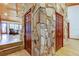 Unique interior with stone wall and wooden doors leading to other rooms at 17210 Orangewood Dr, Lutz, FL 33548