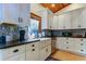 White shaker cabinets,farmhouse sink, and patterned backsplash highlight this kitchen at 17210 Orangewood Dr, Lutz, FL 33548