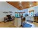 Renovated kitchen features white cabinets, stainless steel appliances, and wood ceilings at 17210 Orangewood Dr, Lutz, FL 33548