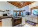 Bright kitchen boasts modern white cabinets, a spacious island, and wood ceilings at 17210 Orangewood Dr, Lutz, FL 33548