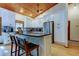 Modern white kitchen with island, stainless steel appliances, and wood ceiling at 17210 Orangewood Dr, Lutz, FL 33548