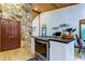 Kitchen island with granite countertop and stone accent wall at 17210 Orangewood Dr, Lutz, FL 33548