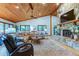 Living room with stone fireplace, vaulted wood ceiling and comfortable seating at 17210 Orangewood Dr, Lutz, FL 33548