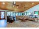 Spacious living room with vaulted wood ceilings, large windows, and comfortable seating at 17210 Orangewood Dr, Lutz, FL 33548