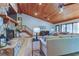 Cozy living room features a large stone fireplace, vaulted ceilings and ample natural light at 17210 Orangewood Dr, Lutz, FL 33548