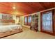 Bright bedroom with a king-size bed, bookshelf, and access to a patio at 17210 Orangewood Dr, Lutz, FL 33548