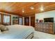 Main bedroom with wood ceiling, built-in shelves, and dresser at 17210 Orangewood Dr, Lutz, FL 33548