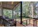 Relaxing screened porch with wicker furniture overlooking a tranquil lake at 17210 Orangewood Dr, Lutz, FL 33548