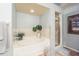 Relaxing bathroom with soaking tub, shower, and neutral tile floors at 1817 Hammocks Ave # 1817, Lutz, FL 33549