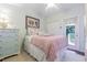 Cozy bedroom with a full-size bed and access to balcony at 1817 Hammocks Ave # 1817, Lutz, FL 33549