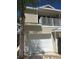 Tan two-story townhouse with attached garage and balcony at 1817 Hammocks Ave # 1817, Lutz, FL 33549