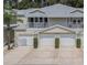 Tan three-unit building with attached garages and balconies at 1817 Hammocks Ave # 1817, Lutz, FL 33549