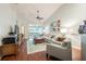 Spacious living room with hardwood floors and access to screened porch at 1817 Hammocks Ave # 1817, Lutz, FL 33549