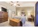 Bright main bedroom with a king-size bed, dresser and access to bathroom at 1817 Hammocks Ave # 1817, Lutz, FL 33549