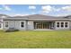 Home features a large backyard with covered patio at 6257 Hidden Branch Dr, Apollo Beach, FL 33572