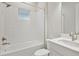 Bathroom with white tile, bathtub and single sink vanity at 6257 Hidden Branch Dr, Apollo Beach, FL 33572