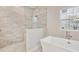 Bathroom featuring a soaking tub, walk-in shower, and tile at 6257 Hidden Branch Dr, Apollo Beach, FL 33572